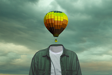 Image showing Contemporary art collage. Male body of model with bright aerostat instead head isolated on blue grey background. Creativity, brain concept .