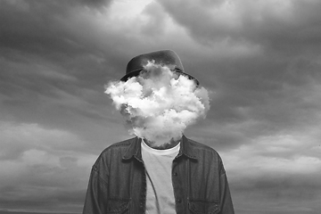 Image showing Contemporary art collage. Black and white, Male body of model with head full of smoke about sky and clouds.