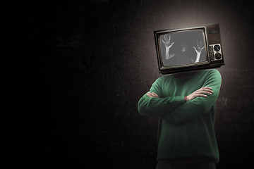 Image showing Contemporary art collage. Male body with TV set instead head isolated on black background. Creativity, brain concept .