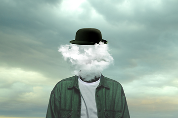 Image showing Contemporary art collage. Male body of model with head full of smoke about sky and clouds.