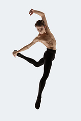 Image showing Young and graceful ballet dancer in minimal black style isolated on white studio background