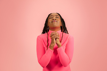 Image showing Young emotional african-american woman isolated on pink studio background, facial expression. Half-lenght portrait with copyspace.