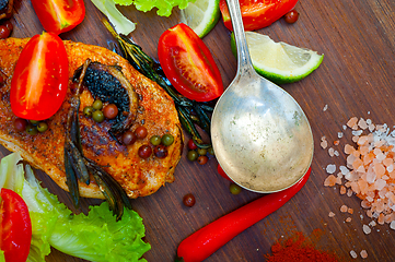 Image showing wood fired hoven cooked chicken breast on wood board