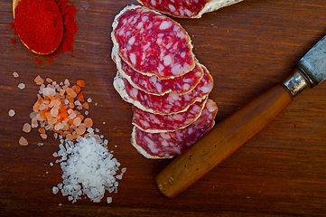 Image showing traditional Italian salame cured sausage sliced on a wood board