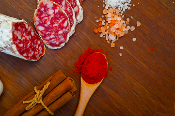 Image showing traditional Italian salame cured sausage sliced on a wood board