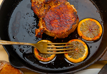 Image showing pork chop seared on iron skillet