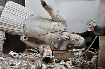 Image showing broken statue and man with plaster mask fragment