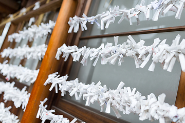 Image showing Paper strips with random fortunes in Japanese temple