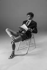 Image showing Young fashionable, stylish man wearing jacket and socks working from home. Fashion during insulation \'cause of coronavirus pandemic