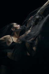 Image showing Graceful classic ballet dancers isolated on black studio background. The grace, artist, movement, action and motion concept.