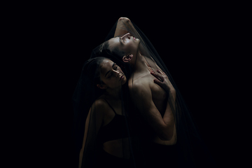 Image showing Graceful classic ballet dancers isolated on black studio background. The grace, artist, movement, action and motion concept.