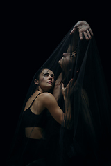 Image showing Graceful classic ballet dancers isolated on black studio background. The grace, artist, movement, action and motion concept.