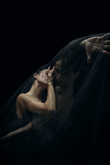 Image showing Graceful classic ballet dancers isolated on black studio background. The grace, artist, movement, action and motion concept.