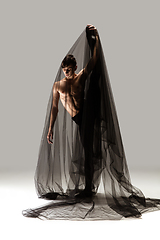 Image showing Graceful classic ballet dancer in black cloth isolated on white studio background. The grace, artist, movement, action and motion concept.