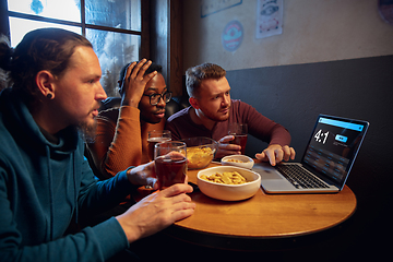 Image showing Excited fans with mobile app for betting and score on their devices. Gambling, emotions