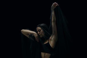 Image showing Graceful classic female ballet dancer isolated on black studio background. The grace, artist, movement, action and motion concept.