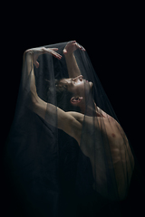 Image showing Graceful classic ballet dancer dancing isolated on dark studio background. The grace, artist, movement, action and motion concept.