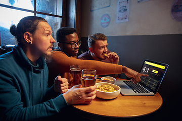 Image showing Excited fans with mobile app for betting and score on their devices. Gambling, emotions