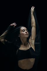 Image showing Graceful classic female ballet dancer isolated on black studio background. The grace, artist, movement, action and motion concept.