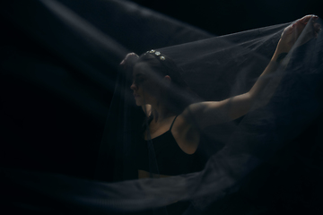 Image showing Graceful classic female ballet dancer isolated on black studio background. The grace, artist, movement, action and motion concept.