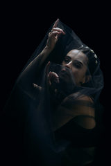 Image showing Graceful classic female ballet dancer isolated on black studio background. The grace, artist, movement, action and motion concept.