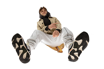 Image showing Young stylish man in modern street style outfit isolated on white background, shot from the bottom