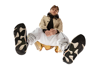 Image showing Young stylish man in modern street style outfit isolated on white background, shot from the bottom