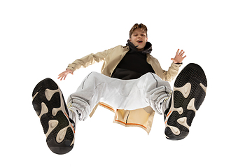 Image showing Young stylish man in modern street style outfit isolated on white background, shot from the bottom