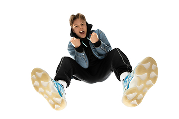 Image showing Young stylish man in modern street style outfit isolated on white background, shot from the bottom