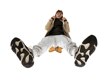 Image showing Young stylish man in modern street style outfit isolated on white background, shot from the bottom