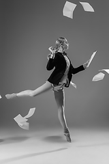 Image showing Young fashionable, stylish woman wearing jacket and socks working from home. Fashion during insulation \'cause of coronavirus pandemic