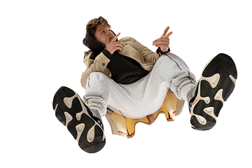 Image showing Young stylish man in modern street style outfit isolated on white background, shot from the bottom