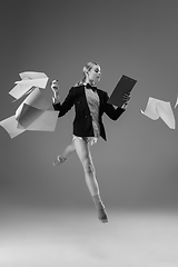 Image showing Young fashionable, stylish woman wearing jacket and socks working from home. Fashion during insulation \'cause of coronavirus pandemic