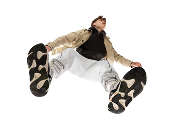 Image showing Young stylish man in modern street style outfit isolated on white background, shot from the bottom