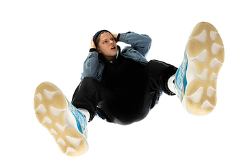 Image showing Young stylish man in modern street style outfit isolated on white background, shot from the bottom