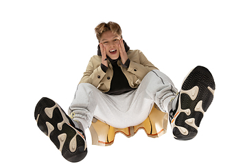 Image showing Young stylish man in modern street style outfit isolated on white background, shot from the bottom