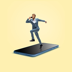 Image showing Office worker, businessman running on the surface of smartphone\'s screen isolated on background