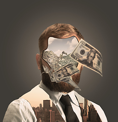 Image showing Portrait of young businessman with bunch of money instead his face on grey background