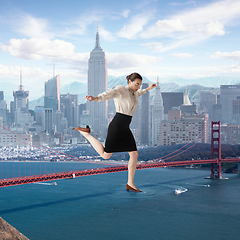 Image showing Office worker, huge businesswoman heading to work on the river through the bridge with megapolis on the background