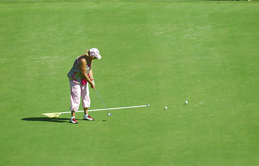 Image showing old woman playing golf