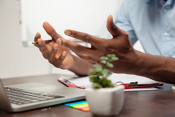 Image showing Online english courses at home. Close up hands of man during teaching students remotely in interior of living room