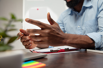 Image showing Online english courses at home. Close up hands of man during teaching students remotely in interior of living room