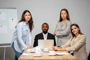 Image showing Young people talking, working during videoconference with colleagues at office or living room