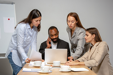 Image showing Young people talking, working during videoconference with colleagues at office or living room