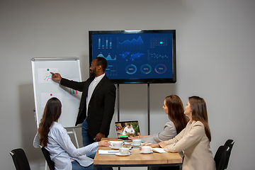 Image showing Young people talking, working during videoconference with colleagues at office or living room