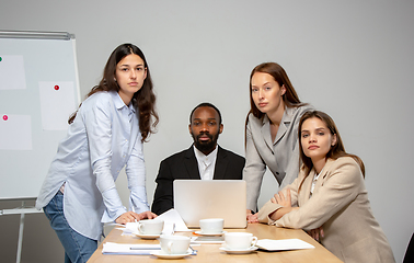 Image showing Young people talking, working during videoconference with colleagues at office or living room