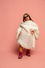 Image showing Caucasian female inclusive model posing on pink studio background in stylish outfit