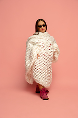Image showing Caucasian female inclusive model posing on pink studio background in stylish outfit