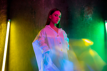 Image showing Caucasian female inclusive model posing on studio background in neon light