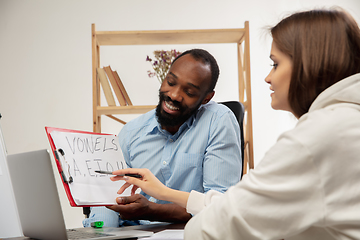 Image showing English courses at home. Smiling man teaches student in interior of living room